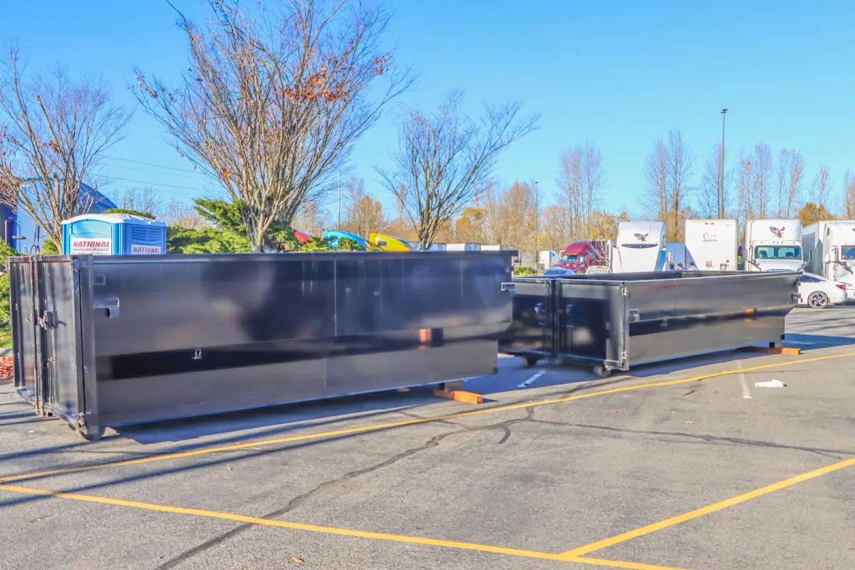 Professional dumpster rental service with roll-off container on residential driveway in McCordsville